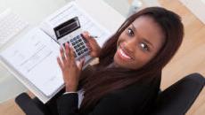 Woman using calculator at desk