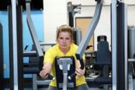 A student working out on a machine in Club 64